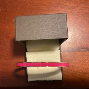 Vintage Kate Spade New York yellow gold tone pink bangle bracelet.